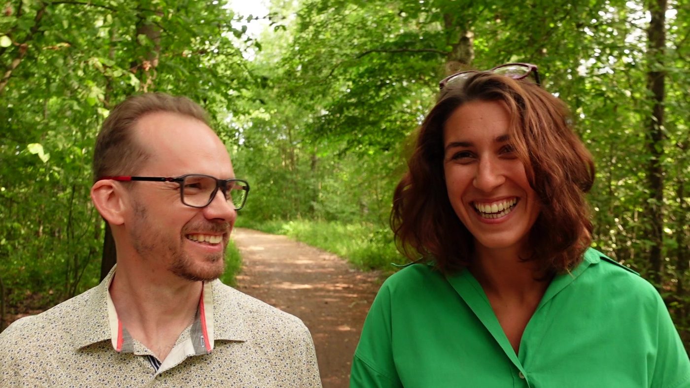 Tommi and Laure laughing on a forest path